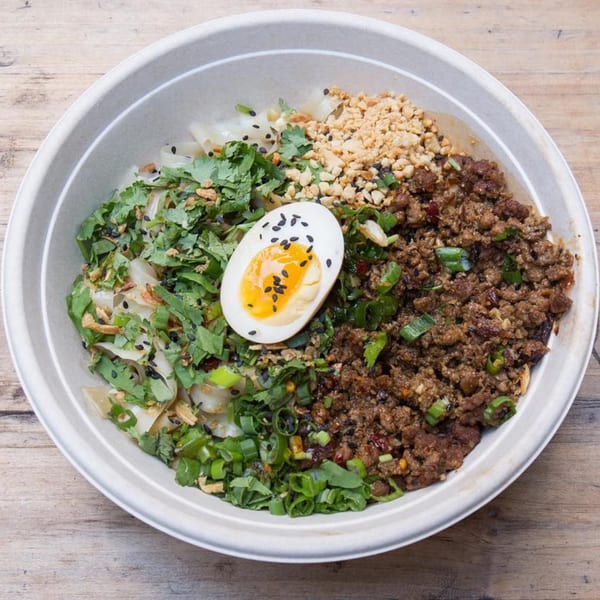 Bao by Kaya's Asian-fusion bowl with ground meat, cilantro, peanuts, and a soft-boiled egg.