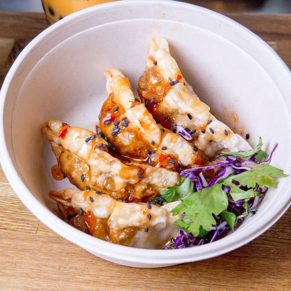 Bao by Kaya's fried dumplings with sweet chili sauce, black sesame seeds, and fresh cilantro.