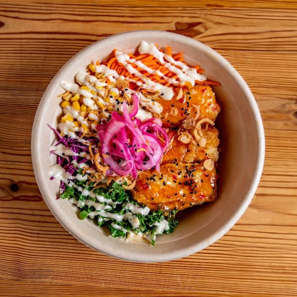 Bao by Kaya's Asian-fusion bowl with crispy chicken, corn, carrots, pickled onions, and kale.