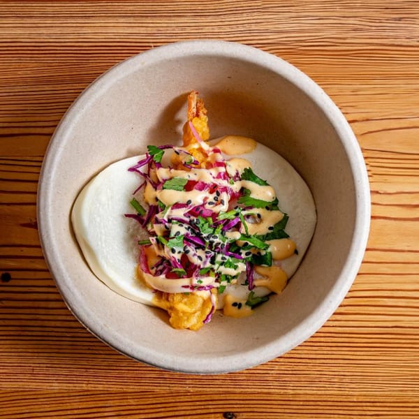 Tempura shrimp bao bun with red cabbage, cilantro, and spicy mayo in a bowl.